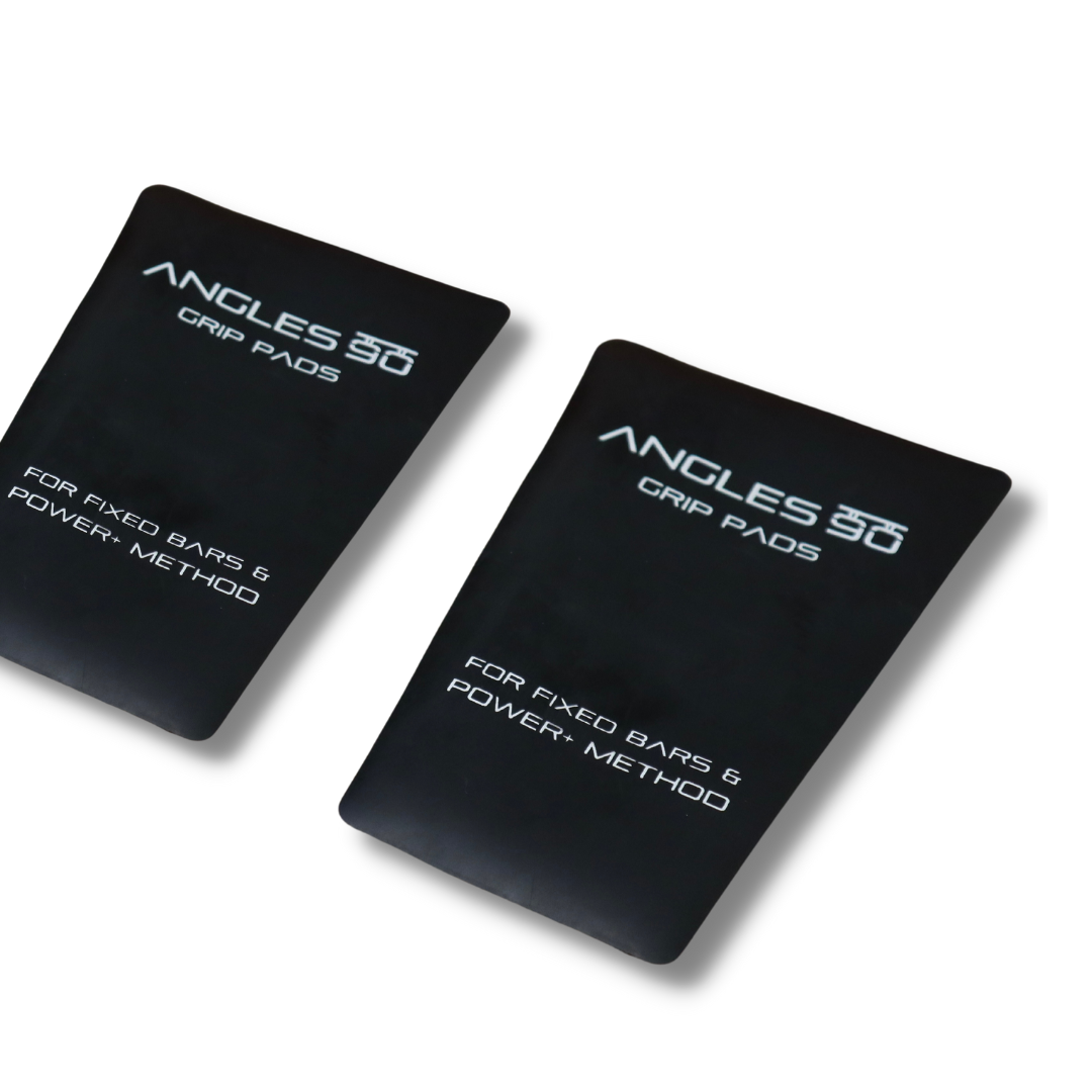 Two A90 Grip Pads lying on a white surface, designed for use with fixed bars to enhance POWER+ GRIP Method training.