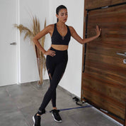 A person engaging in a home workout, using the A90 Leg Day Set for leg exercises with a focus on health and fitness.