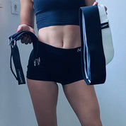 Fitness-focused individual holding an A90 Leg Day Set and resistance bands, ready for a gym session.