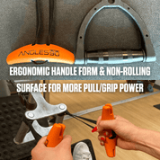 A person using a pair of ergonomically designed Angles90 Wood (Limited Edition) Grips with orange handles that offer better grip and pull power, set against a background of other hardware tools.